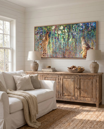 Giraffes canvas print Canopy Cornucopia by Iris Scott styled in an elegant home interior, showcasing two giraffes reaching upward into colorful foliage and safari-inspired botanical artwork